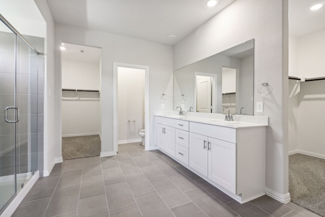418 Stagg St, Mckinney, TX 75069 - full bathroom featuring toilet, a stall shower, double vanity, recessed lighting, and a spacious closet