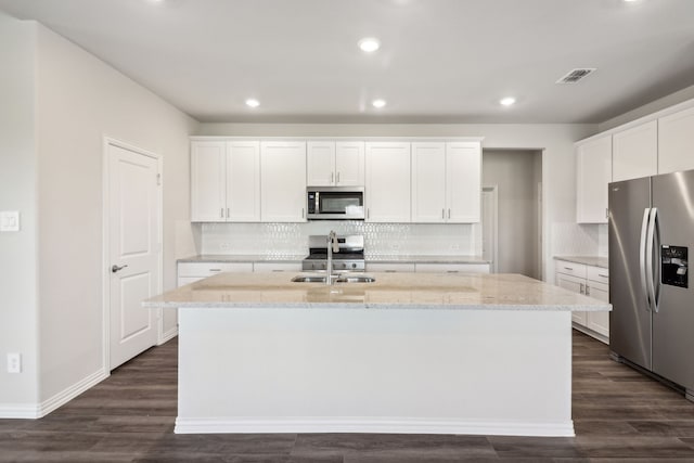 418 Stagg St, Mckinney, TX 75069 - kitchen featuring appliances with stainless steel finishes, a kitchen island with sink, white cabinetry, backsplash, and recessed lighting