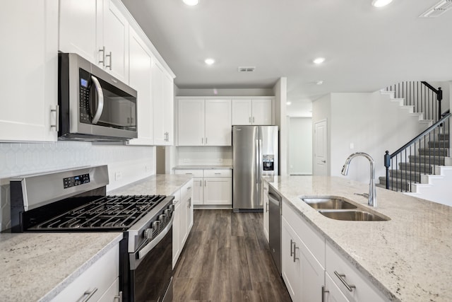 418 Stagg St, Mckinney, TX 75069 - kitchen featuring appliances with stainless steel finishes, a sink, white cabinets, dark wood-style floors, and recessed lighting