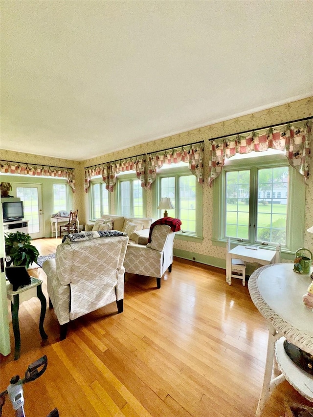 500 S Ross Ave, Mexia, TX 76667 - living area featuring wallpapered walls and light wood-style floors