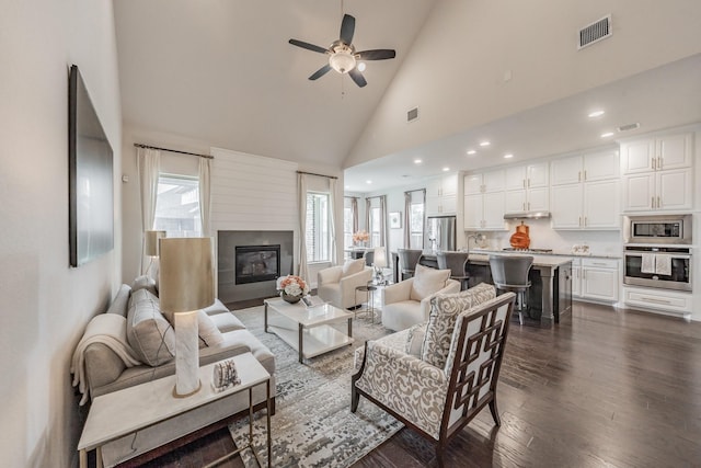 3723 Birch Wood Ct, Northlake, TX 76226 - living room with high vaulted ceiling, dark wood-style flooring, ceiling fan, a glass covered fireplace, and recessed lighting