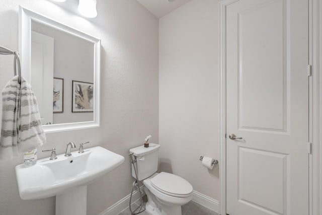 3723 Birch Wood Ct, Northlake, TX 76226 - half bath featuring toilet, a sink, baseboards, and tile patterned flooring