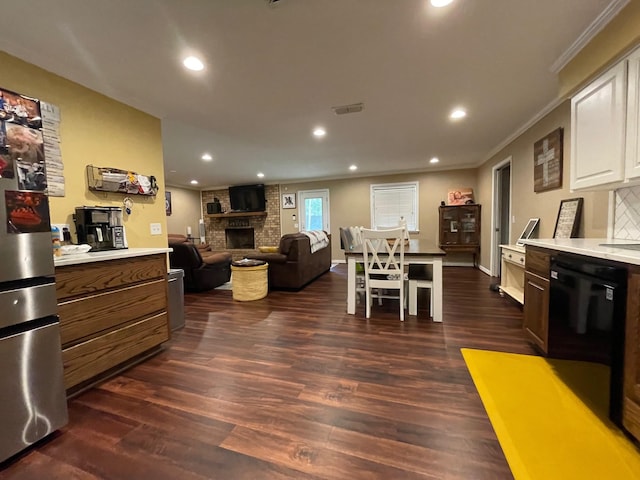 4054 Lakeshore Dr, Lone Star, TX 75668 - living room with a fireplace, ornamental molding, dark wood-type flooring, recessed lighting, and baseboards