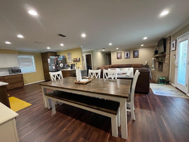 4054 Lakeshore Dr, Lone Star, TX 75668 - dining room with ornamental molding, dark wood finished floors, recessed lighting, baseboards, and a brick fireplace