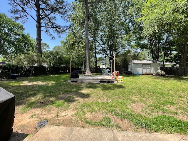 4054 Lakeshore Dr, Lone Star, TX 75668 - view of yard featuring a deck, a storage shed, and an outbuilding