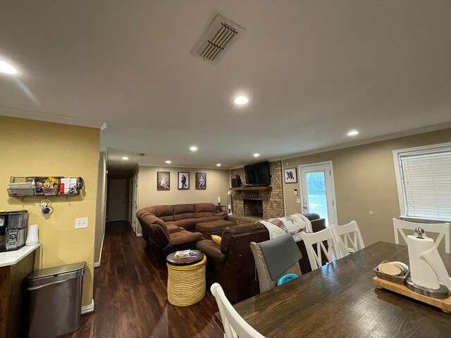 4054 Lakeshore Dr, Lone Star, TX 75668 - dining area featuring a brick fireplace, crown molding, dark wood finished floors, recessed lighting, and baseboards