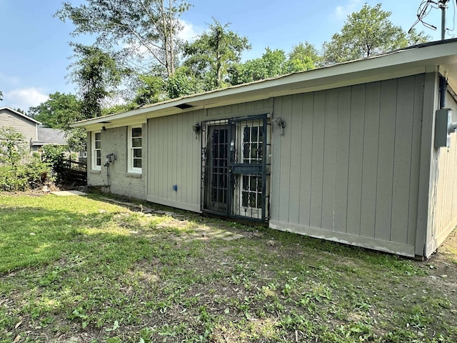 view of side of property with a lawn