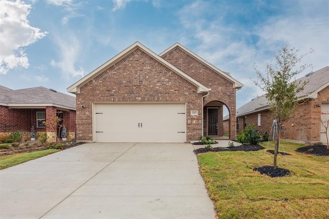 1683 Timpson Dr, Forney, TX 75126 - view of front of house featuring brick siding, concrete driveway, an attached garage, and a front lawn