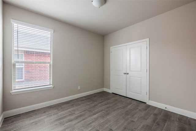 1683 Timpson Dr, Forney, TX 75126 - unfurnished bedroom with wood finished floors, multiple windows, and baseboards