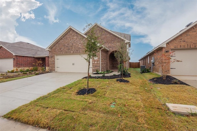 1683 Timpson Dr, Forney, TX 75126 - view of front facade featuring brick siding, central AC unit, a garage, and driveway