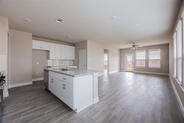 1683 Timpson Dr, Forney, TX 75126 - kitchen with a sink, stainless steel dishwasher, dark wood-style floors, baseboards, and white cabinetry