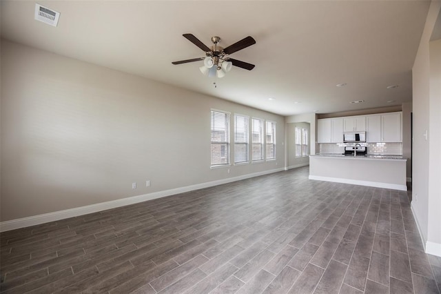 1683 Timpson Dr, Forney, TX 75126 - unfurnished living room featuring baseboards, dark wood-type flooring, ceiling fan, and recessed lighting