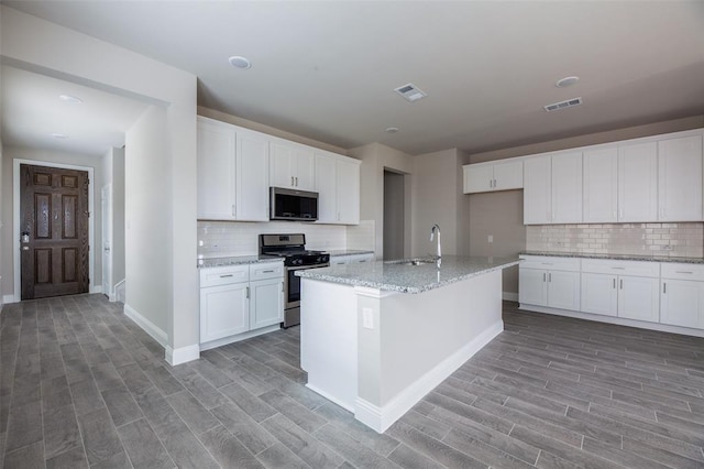 1683 Timpson Dr, Forney, TX 75126 - kitchen featuring appliances with stainless steel finishes, light wood finished floors, backsplash, a sink, and baseboards