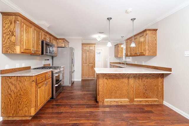 2103 S High St, Brady, TX 76825 - kitchen with stainless steel appliances, a peninsula, dark wood-style floors, light countertops, and crown molding