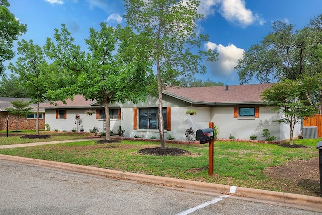 2103 S High St, Brady, TX 76825 - single story home featuring central air condition unit, brick siding, and a front lawn