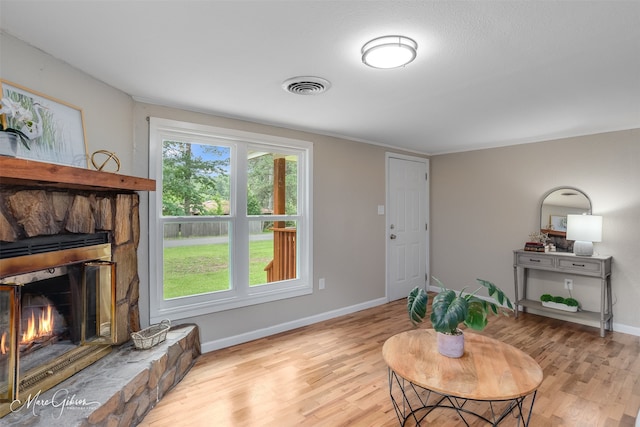 6470 Faust Dr, Shreveport, LA 71129 - living room with light wood-style flooring, baseboards, and a fireplace