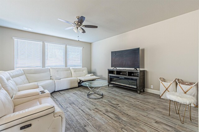 3001 Spring Ct, Midlothian, TX 76065 - living room with ceiling fan, plenty of natural light, wood finished floors, and baseboards