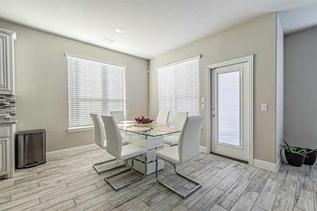 3001 Spring Ct, Midlothian, TX 76065 - dining area featuring light wood-type flooring, baseboards, and healthy amount of natural light