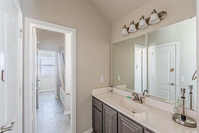 3001 Spring Ct, Midlothian, TX 76065 - bathroom featuring tile patterned floors, vaulted ceiling, shower / tub combo with curtain, vanity, and baseboards