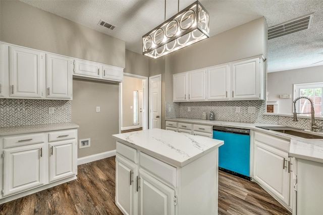 11016 Huntington Rd, Frisco, TX 75035 - kitchen featuring dishwashing machine, a textured ceiling, a sink, backsplash, and light stone counters