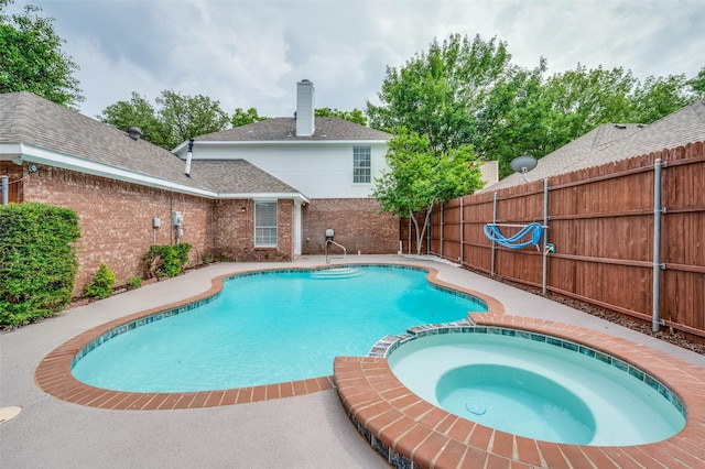 11016 Huntington Rd, Frisco, TX 75035 - view of swimming pool with fence and a pool with connected hot tub