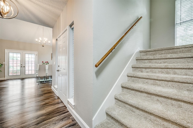 11016 Huntington Rd, Frisco, TX 75035 - stairs featuring a chandelier, french doors, wood finished floors, lofted ceiling, and baseboards