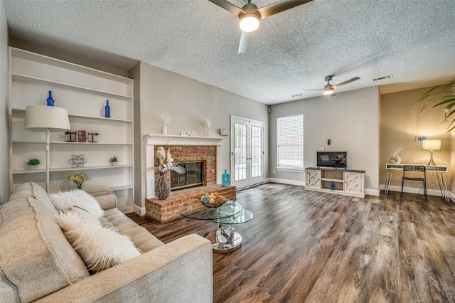 11016 Huntington Rd, Frisco, TX 75035 - living area featuring ceiling fan, wood finished floors, a textured ceiling, baseboards, and a fireplace
