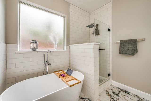 11016 Huntington Rd, Frisco, TX 75035 - bathroom with marble finish floors, a stall shower, a freestanding bath, and healthy amount of natural light