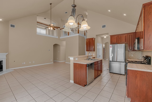 10317 Colfax Dr, Mckinney, TX 75072 - kitchen with stainless steel appliances, a sink, open floor plan, arched walkways, and high vaulted ceiling