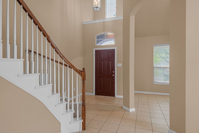 10317 Colfax Dr, Mckinney, TX 75072 - tiled entryway featuring a towering ceiling, stairs, and baseboards