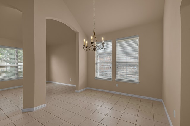 10317 Colfax Dr, Mckinney, TX 75072 - empty room with a chandelier, arched walkways, light tile patterned flooring, vaulted ceiling, and baseboards