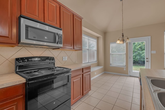 10317 Colfax Dr, Mckinney, TX 75072 - kitchen with stainless steel microwave, black / electric stove, a chandelier, tasteful backsplash, and light countertops