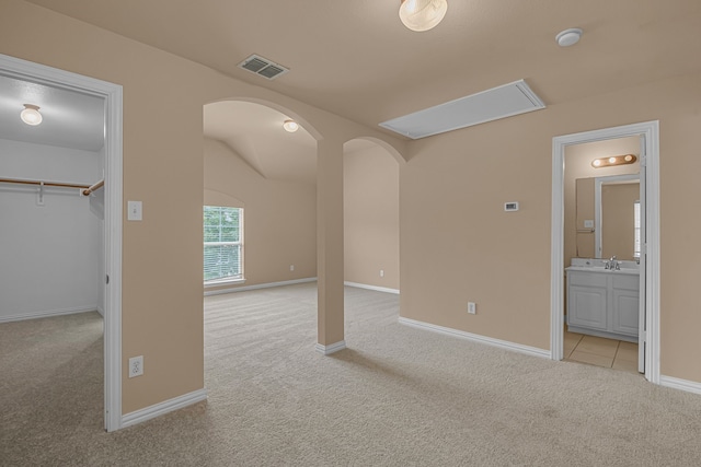 10317 Colfax Dr, Mckinney, TX 75072 - unfurnished bedroom featuring carpet, arched walkways, a spacious closet, a sink, and ensuite bath
