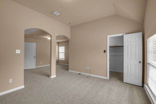 10317 Colfax Dr, Mckinney, TX 75072 - unfurnished bedroom featuring arched walkways, light colored carpet, baseboards, a spacious closet, and lofted ceiling
