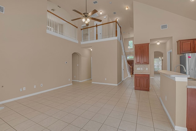10317 Colfax Dr, Mckinney, TX 75072 - kitchen featuring arched walkways, ceiling fan, high vaulted ceiling, freestanding refrigerator, and open floor plan