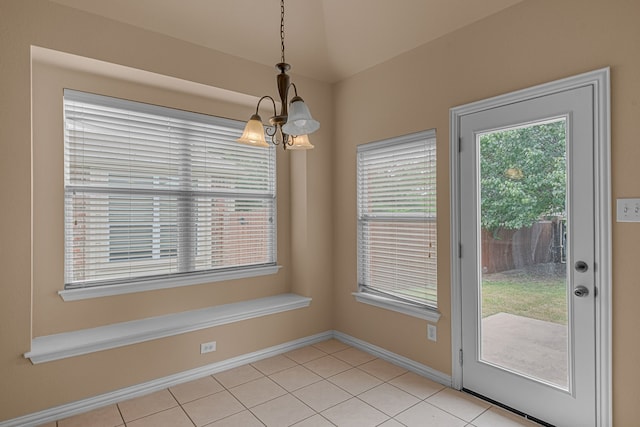 10317 Colfax Dr, Mckinney, TX 75072 - unfurnished dining area with a chandelier, light tile patterned floors, and baseboards