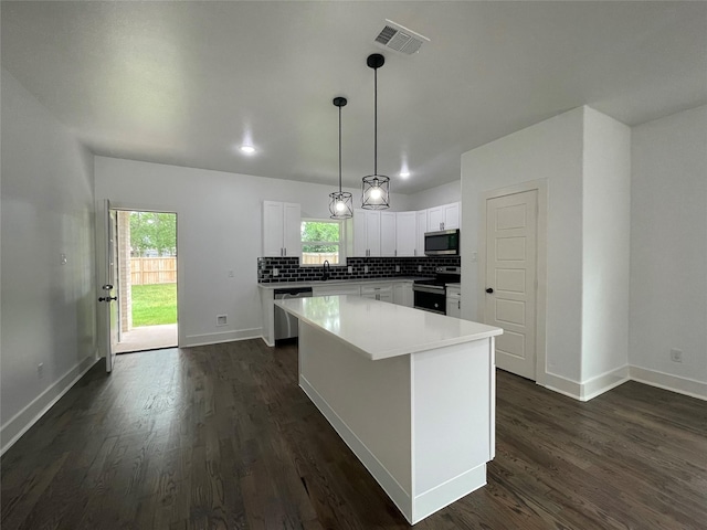 206 E Birch St, Campbell, TX 75422 - kitchen with appliances with stainless steel finishes, a center island, white cabinetry, decorative backsplash, and baseboards