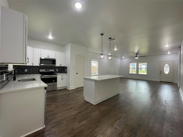 206 E Birch St, Campbell, TX 75422 - kitchen with a sink, stainless steel appliances, a center island, dark wood-type flooring, and ceiling fan