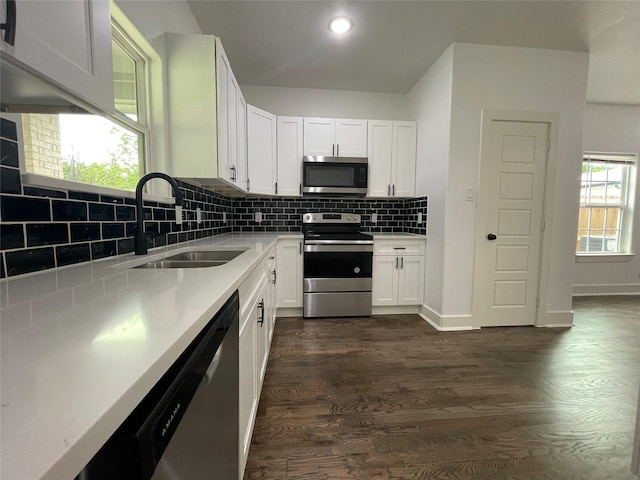 206 E Birch St, Campbell, TX 75422 - kitchen featuring appliances with stainless steel finishes, a sink, white cabinetry, tasteful backsplash, and dark wood-style flooring