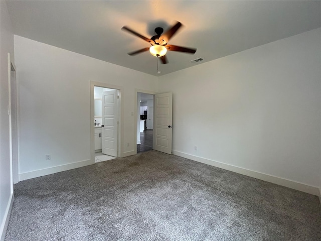 206 E Birch St, Campbell, TX 75422 - unfurnished bedroom featuring carpet flooring, baseboards, ensuite bath, and ceiling fan