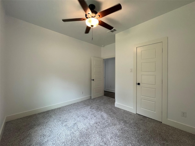 206 E Birch St, Campbell, TX 75422 - unfurnished bedroom featuring dark carpet, baseboards, and a ceiling fan