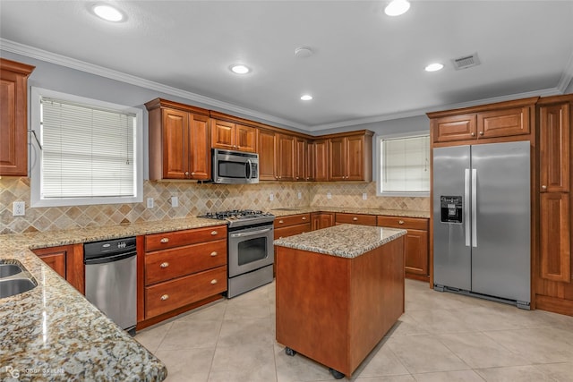704 Taylor Bend St, Haughton, LA 71037 - kitchen featuring stainless steel appliances, ornamental molding, light stone countertops, tasteful backsplash, and brown cabinets
