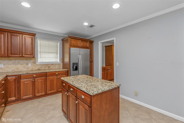 704 Taylor Bend St, Haughton, LA 71037 - kitchen with stainless steel refrigerator with ice dispenser, light stone counters, crown molding, light tile patterned flooring, and backsplash