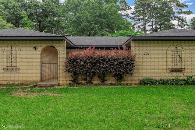 704 Taylor Bend St, Haughton, LA 71037 - view of front facade featuring brick siding, a shingled roof, and a front lawn