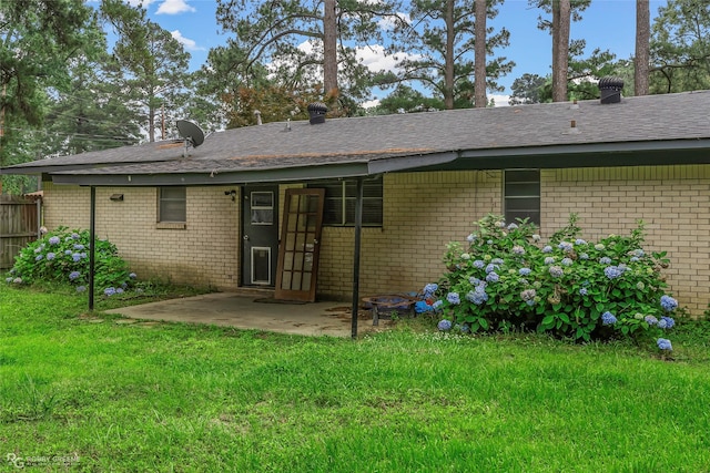 704 Taylor Bend St, Haughton, LA 71037 - back of property featuring brick siding, a patio, and roof with shingles