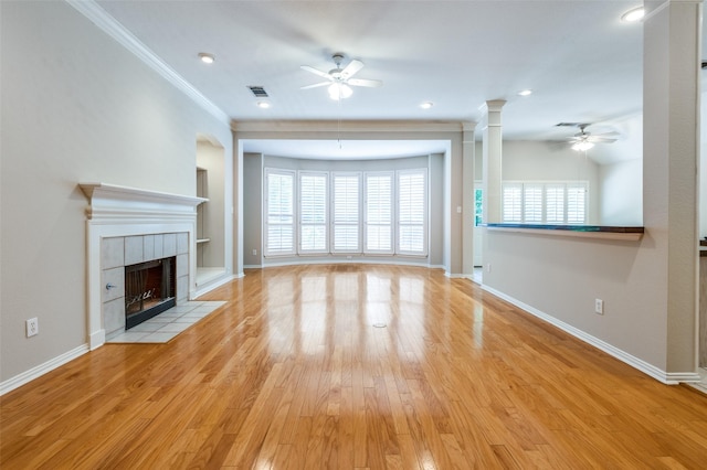 3002 Chukar Dr, Mckinney, TX 75072 - unfurnished living room with a ceiling fan, ornamental molding, a tile fireplace, light wood-type flooring, and baseboards
