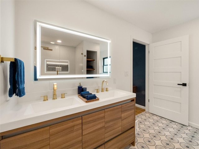445 Melrose Dr, Richardson, TX 75080 - bathroom with double vanity and baseboards
