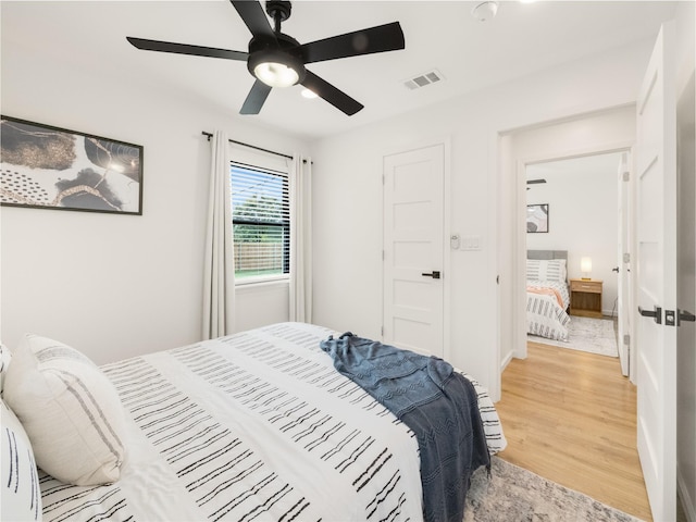445 Melrose Dr, Richardson, TX 75080 - bedroom featuring light wood finished floors and ceiling fan