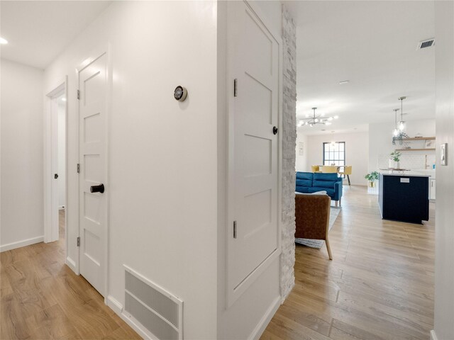 445 Melrose Dr, Richardson, TX 75080 - hallway featuring a chandelier, light wood finished floors, baseboards, and recessed lighting