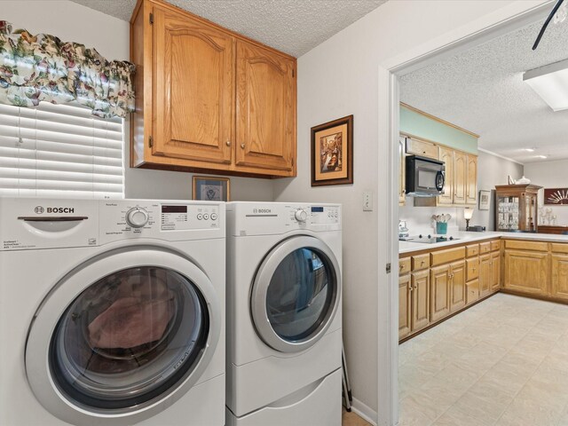 205 Brookview Dr, Decatur, TX 76234 - washroom with a textured ceiling, washer and clothes dryer, and cabinet space